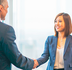 business woman shaking hands with a trading partner